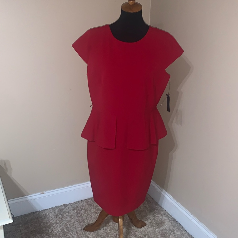 Red dress with peplum. Misses size 16. Zips up the back.